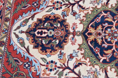 Lot 517 - Machine made cream and red ground wool rug
