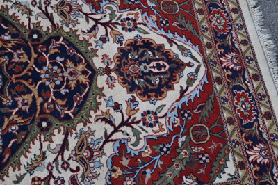 Lot 517 - Machine made cream and red ground wool rug