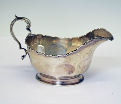 Lot 197 - George V silver sauceboat with flying scroll handle