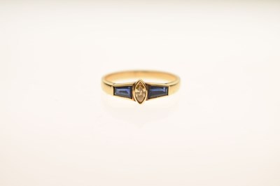 Lot 21 - Fancy cut diamond and sapphire three-stone yellow metal ring