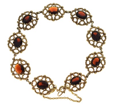 Lot 114 - 9ct gold garnet set panel bracelet