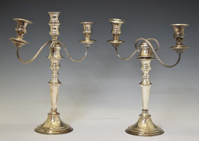 Lot 314 - Pair of 20th century electroplated twin-branch, three-light candelabra