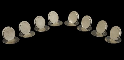 Lot 74 - Asprey & Co - Set of eight George V silver menu holders of plain circular form