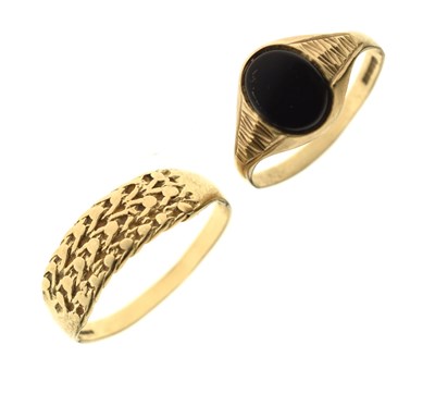 Lot 24 - 9ct gold 'keeper' ring and 9ct gold onyx signet ring