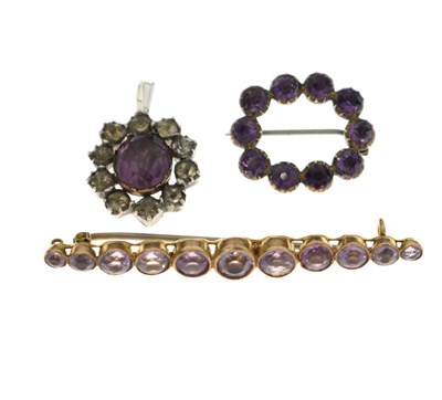Lot 52 - Early 20th century amethyst bar brooch, an amethyst wreath brooch and a paste pendant (3)