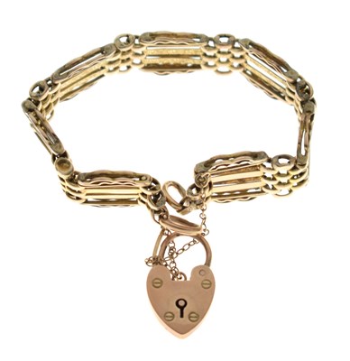 Lot 83 - Yellow metal (9ct) 'rose gold' gate link bracelet with heart padlock, 19g approx