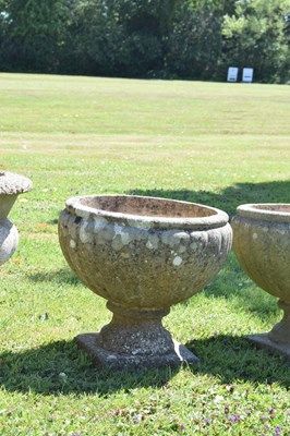 Lot 553 - Two pairs of composition stone garden urns / planters
