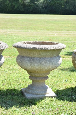 Lot 553 - Two pairs of composition stone garden urns / planters