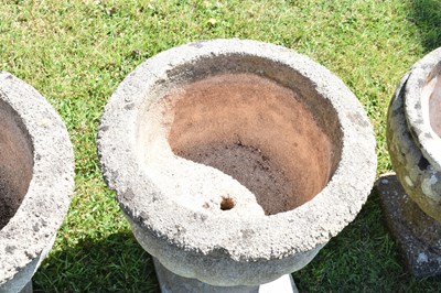 Lot 553 - Two pairs of composition stone garden urns / planters