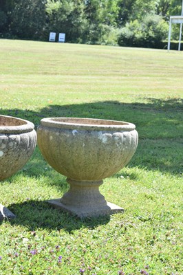 Lot 553 - Two pairs of composition stone garden urns / planters