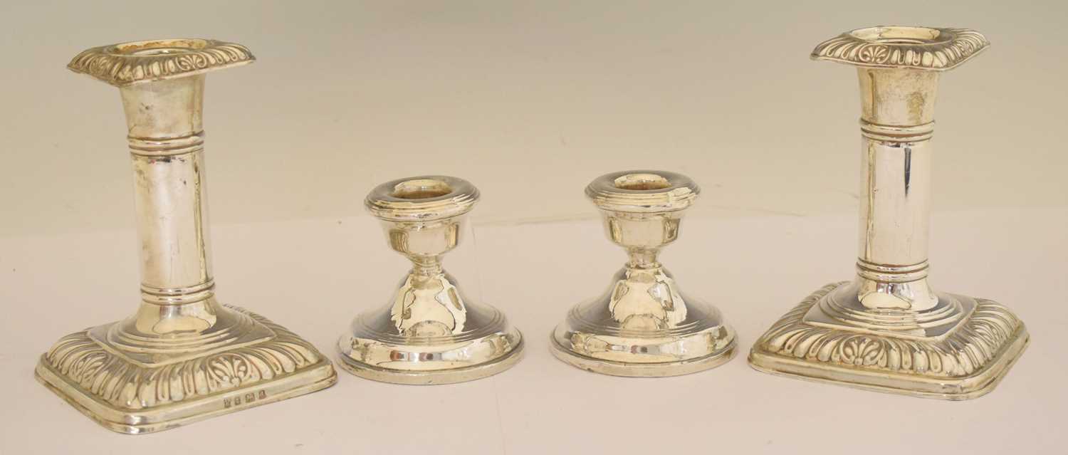 Lot 164 - Two pairs of silver candlesticks