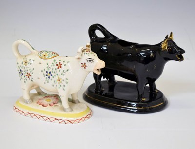 Lot 300 - Two Staffordshire cow creamers