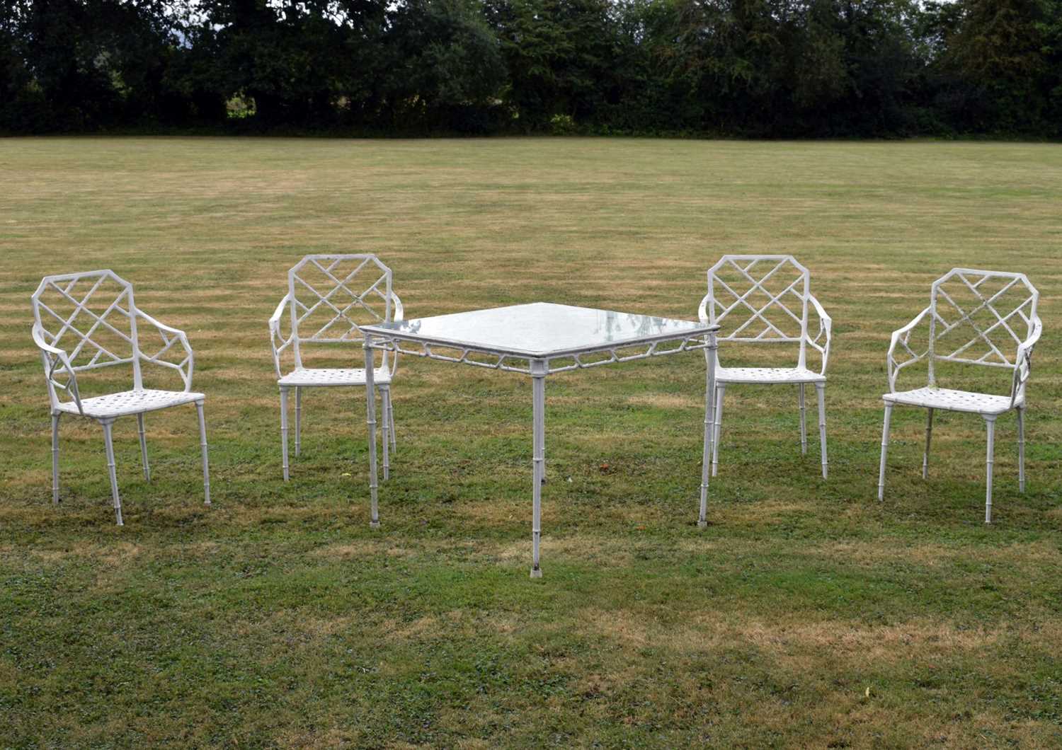 Lot 543 - White painted cast metal bamboo-effect garden / patio set