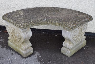 Lot 711 - Composite stone curved garden seat having decorative supports