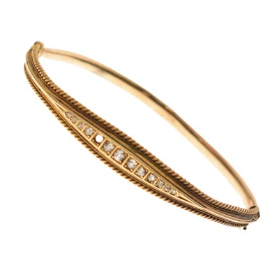 Lot 82 - Early 20th century diamond set yellow metal bangle, stamped 15ct