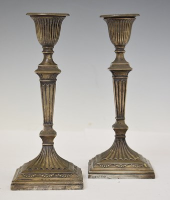Lot 218 - Pair of late Victorian silver column candlesticks