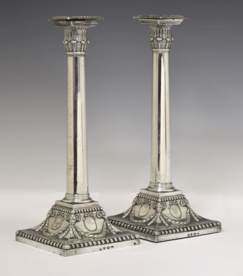 Lot 127 - Large pair of George III silver candlesticks of plain column form