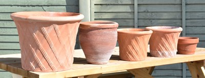 Lot 682 - Graduated set of three terracotta garden planters