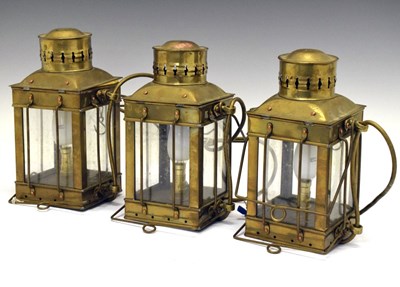 Lot 255 - Set of three brass cargo lamps