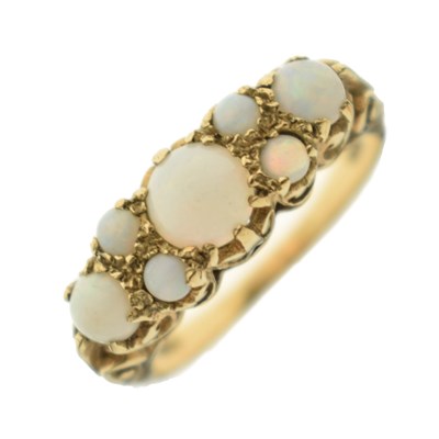 Lot 25 - 1960s opal seven-stone 9ct gold dress ring