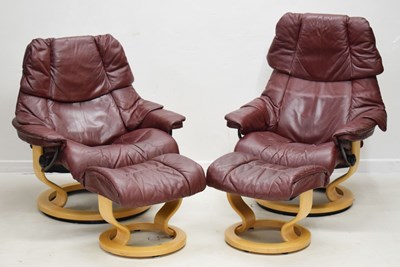 Lot 654 - Near pair of Stressless reclining chairs with footstools