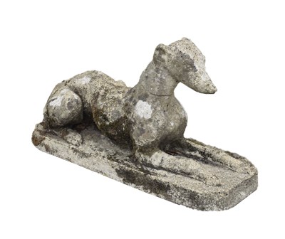 Lot 434 - Weathered composition figure of a recumbent greyhound or whippet dog