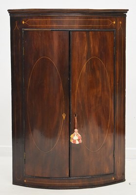 Lot 646 - George III inlaid mahogany bowfront corner cupboard