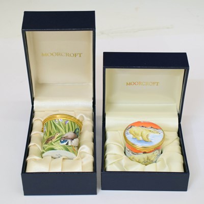 Lot 456 - Moorcroft - Two miniature enamel cylindrical boxes with hinged covers