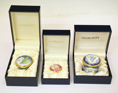 Lot 462 - Moorcroft - Three miniature enamel cylindrical boxes with covers