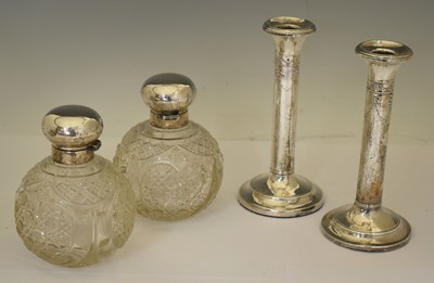 Lot 194 - A pair of Edward VII silver candlesticks, Elizabeth II silver topped glass scent bottles