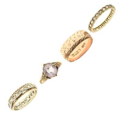 Lot 97 - Four rings to include a 9ct rose gold wedding band, etc