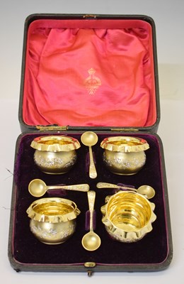 Lot 271 - Cased set of four Victorian silver gilt salts with foliate decoration and crimped rims
