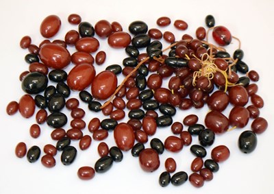 Lot 202 - Group of loose 'cherry amber' beads, etc