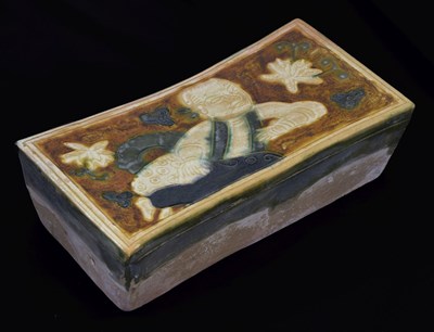 Lot 211 - Chinese sancai glazed terracotta pillow or neck rest