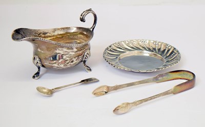 Lot 308 - Victorian silver dish, George III sugar tongs, George VI silver sauce boat, etc
