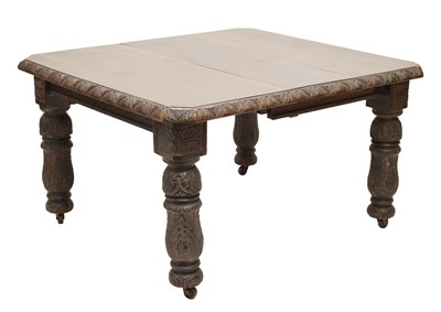 Lot 564 - Edwardian carved oak wind-out extending dining table with one leaf