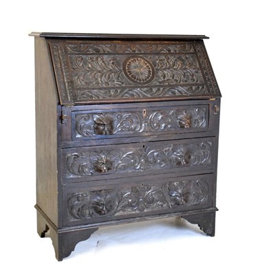 Lot 584 - Carved oak bureau