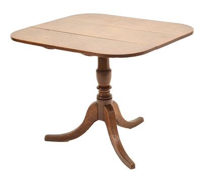 Lot 552 - Late George III oak snap-top tripod occasional table