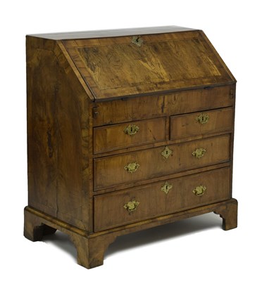 Lot 524 - George II figured walnut, crossbanded and featherbanded bureau