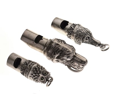 Lot 136 - Three white metal novelty whistles