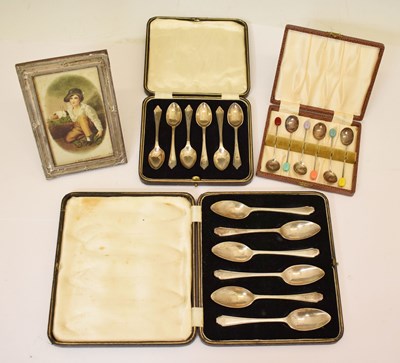 Lot 148 - Three cased sets of silver spoons together with a silver-mounted photograph frame