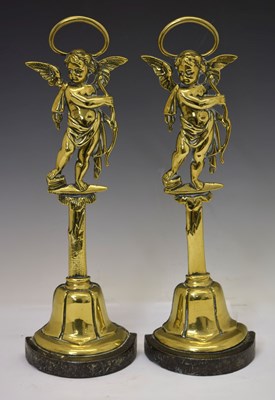 Lot 151 - Two 19th century brass Cupid door porters or doorstops