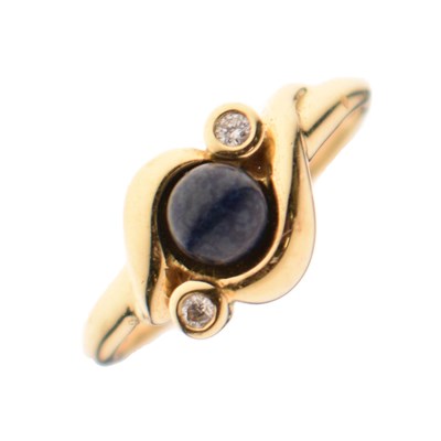 Lot 22 - Blue hardstone and diamond three-stone crossover ring