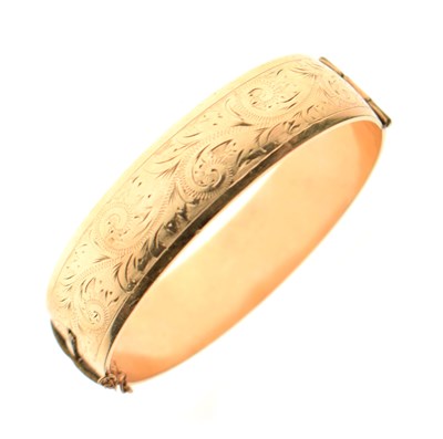 Lot 123 - Yellow metal snap bangle marked '9ct Metal Core'