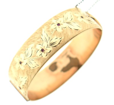 Lot 124 - Rolled gold gem-set hinged bangle