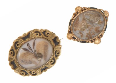 Lot 72 - Mid 19th century yellow metal mourning brooch together with a similar brooch (2)