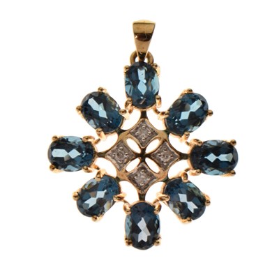 Lot 90 - 'London' blue topaz and diamond starburst 9ct gold pendant