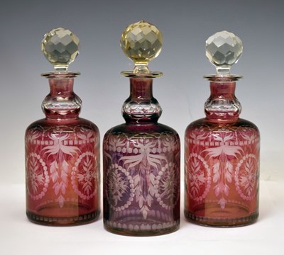 Lot 186 - Three cranberry flashed glass decanters
