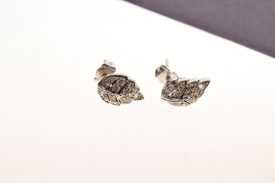 Lot 65 - Pair of unmarked white metal leaf design diamond set stud earrings