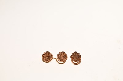 Lot 94 - Three small rose gold flower design studs